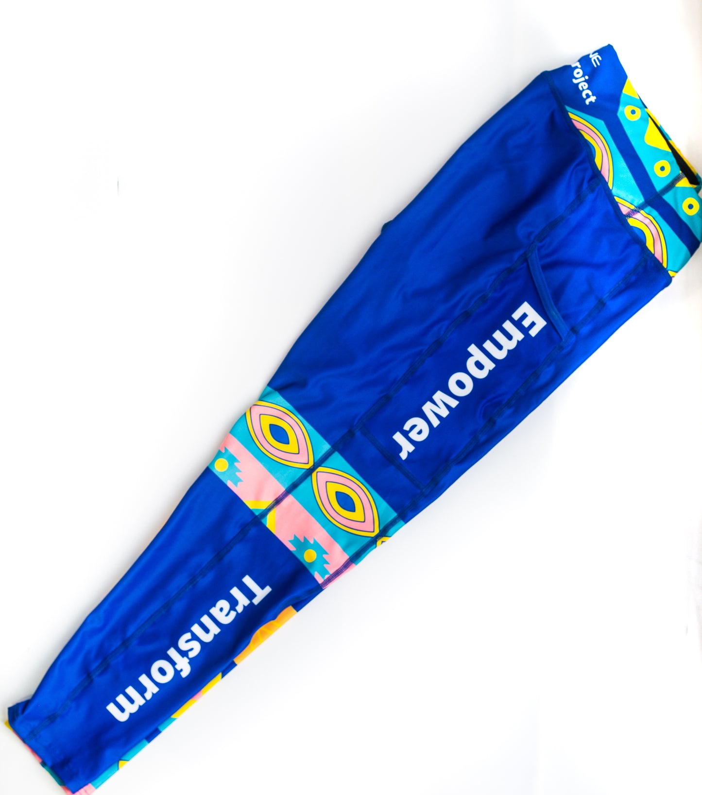 Blue leggings with african design in colour with the words empower and transform on the side come in plus sizes with a side pocket