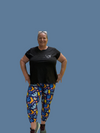 Brenda in the new brightly coloured Happy Dance leggings they have a dark blue background with different shapes in Yellow, light blue, teal